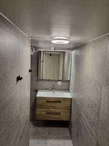 a bathroom with a sink and a mirror at Leilighet nær Trondheim by. in Trondheim