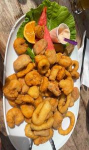 a plate of food with shrimp and vegetables on a table at Sol-v-mar in Penha