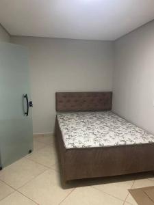 a bedroom with a bed in the corner of a room at Sol-v-mar in Penha