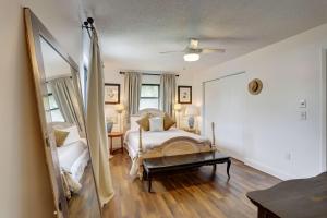 a bedroom with a bed and a large mirror at Blue Beach Cottage in St. Pete Beach