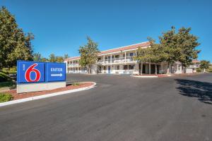 a building with a sign in the middle of a road at Motel 6-Redding, CA - South in Redding