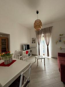 a living room with a table and a dining room at Luna's Apartment in Sant'Agnello