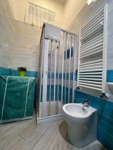 a bathroom with a toilet and a sink and a shower at Luna's Apartment in Sant'Agnello
