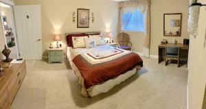a bedroom with a large bed and a desk and a desk at Monroe Street Suites in Pittsfield