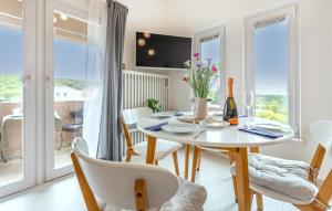 a dining room with a table and chairs with a view at Stunning Apartment In Izola With 1 Bedrooms, Wifi And Outdoor Swimming Pool in Izola