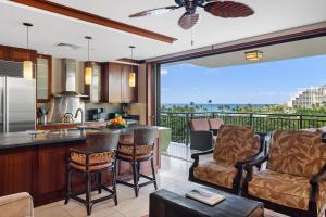 a kitchen and living room with a view of the ocean at Ko Olina Beach Villas B602 in Kapolei