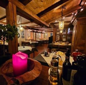 a restaurant with a table with bottles of wine at Hotel Taverne zur Linde in Bischofszell