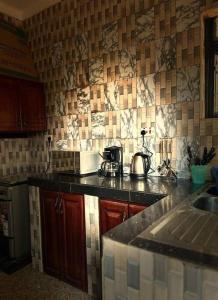 a kitchen with a sink and a counter top at Chayil Loft Mulago in Kampala