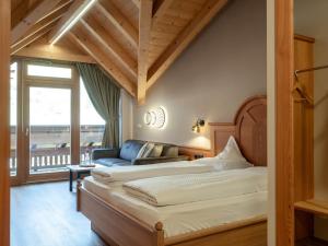 a bedroom with two beds and a couch at Hotel Bacherhof in Maranza +75 photos