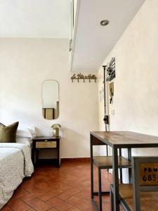 a bedroom with a bed and a table and a table sidx sidx sidx at Stilnovo House in Florence