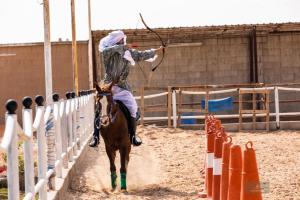 a person riding a horse with a lasso at Working Line Traditional Equestrian Centre in Riyadh