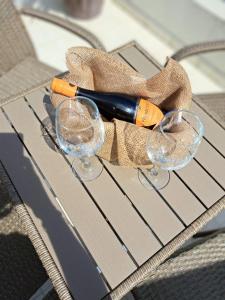 a table with two glasses and a bottle of wine at The White House in Nesebar