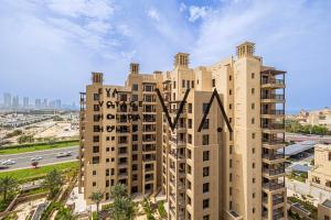 an apartment building in the middle of a city at Luxurious Living Redefined at Asayel 3 in Dubai