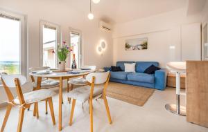 a living room with a table and a blue couch at Beautiful Apartment In Izola With Wifi in Izola