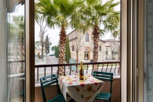 a table on a balcony with a view of a street at SORRIDI AL LAGO in Sirmione