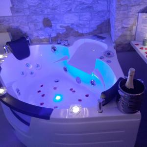 a bathroom with a jacuzzi tub with a bottle of champagne at LA MURGIA casa vacanze B&B in Grumo Appula +89 photos