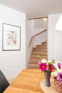 a dining room with a table with flowers on it at Alte Waescherei _9463_ in List