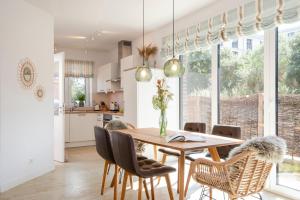 a kitchen and dining room with a wooden table and chairs at Alte Waescherei _9464_ in List