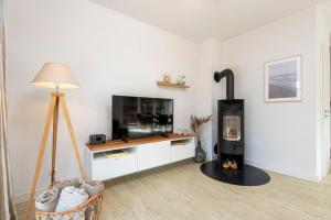 a living room with a fireplace and a tv at Alte Waescherei _9464_ in List