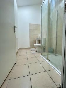a bathroom with a glass shower and a toilet at Homestay-Close to Coventry City and University I Free Parking I Wi-Fi in Coventry
