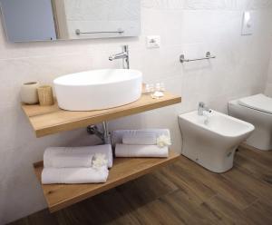 a bathroom with a sink and a toilet at Villa Azzurra in Lampedusa