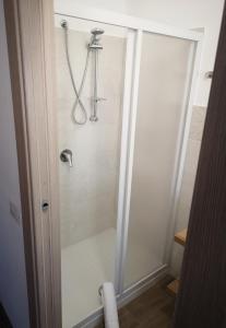 a shower in a bathroom with a glass door at Villa Azzurra in Lampedusa