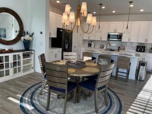 a kitchen and dining room with a table and chairs at New Luxury Townhome, Stay close in style! in Davenport