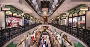 a large shopping mall with a clock on the ceiling at Sydney CBD Luxury Furnished Apartment & City Views in Sydney