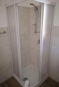 a shower with a glass door in a bathroom at Villa Azzurra in Lampedusa