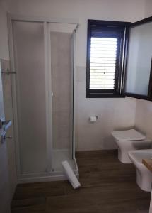 a bathroom with a shower and a toilet and a sink at Villa Azzurra in Lampedusa