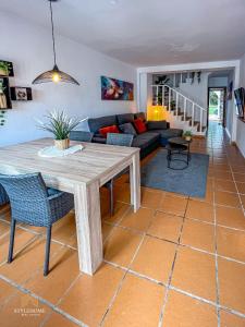 a living room with a table and a couch at Casa El Grande in Torrevieja