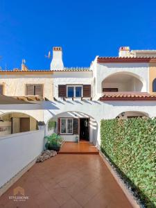 a large white house with a pathway leading to the front door at Casa El Grande in Torrevieja