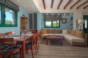 a living room with a couch and a table at Villa Vera in Paradeísion