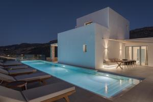a swimming pool in a villa at night at Retreat Hill Luxury Villas Mykonos in Mýkonos City
