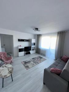a living room with a couch and a table at Apartament central pe pietonala nr2 in Hunedoara +26 photos