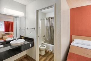 a hotel room with a bathroom with a bed and a sink at Motel 6-Everett, WA - South in Wintermutes Corner