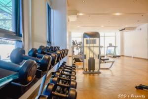 a gym with dumbbells and machines in a room at 56sqm. Condo at Mactan Newtown w/Free Beach and Pool Access! in Lapu Lapu City