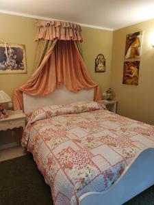 a bedroom with a bed with a quilt on it at Una Franca Camere Di Charme in Biella