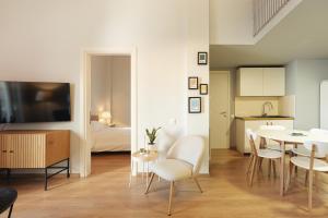 a living room with a table and chairs and a kitchen at Aristotelous 22 Suites in Thessaloniki