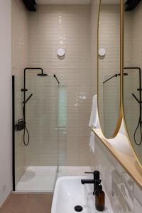 a bathroom with a shower and a sink and mirror at Luxury Eco Escape in South Devon in Darlington