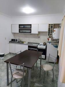 a kitchen with a table and chairs and a stove at Departamento Mirasol in Federación