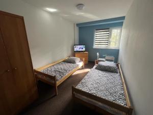 a room with two beds and a television in it at U Marty in Jaworzno