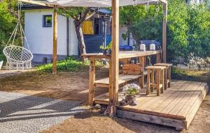 a wooden pergola with a table and chairs on a deck at 3 Bedroom Cozy Home In Slite in Slite