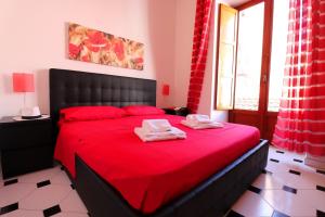 a bedroom with a red bed with two towels on it at Estate4home - Sorrento Hearts in Sorrento