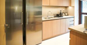 a kitchen with a stainless steel refrigerator and a sink at Luxury Villa by the sea in Fujairah