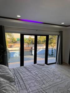 a bedroom with a bed and a large window at La Vega City home with pool in Concepción de La Vega