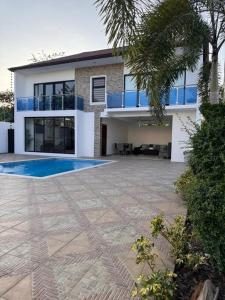 a house with a swimming pool in front of it at La Vega City home with pool in Concepción de La Vega