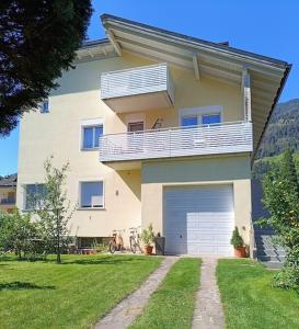 a large house with a balcony and a garage at Apartment 66 in Bressanone