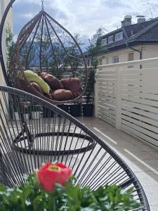 a swing on a balcony with a flower at Apartment 66 in Bressanone