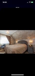 a bedroom with a large bed and a stone wall at Feel like home Apartment SELF CHECK IN in Klaipėda